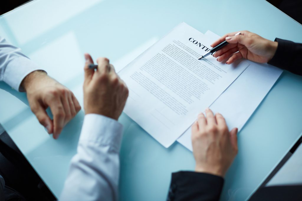 Woman manager explaining contract provisions to client